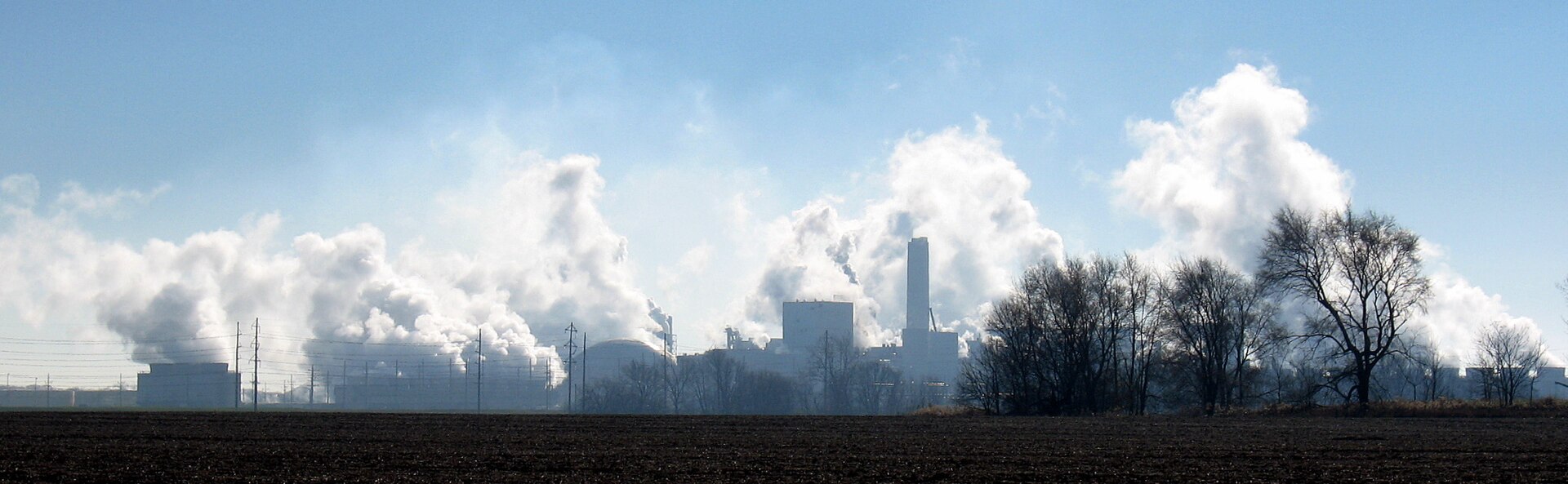 Industrial skyline of corn processing plants with steam plumes at Decatur, Illinois