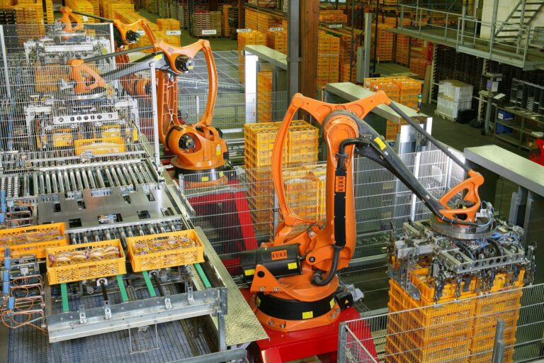 Industrial robots palletizing packaged bread in an automated food factory