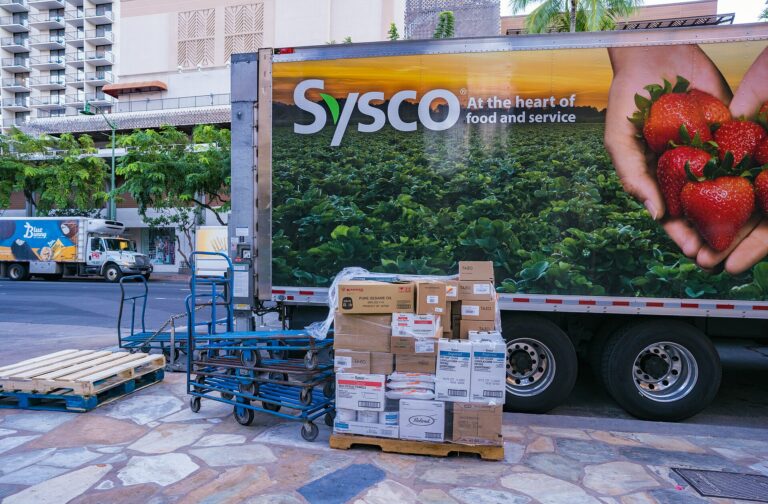 Foodservice distribution truck unloading pallets of supplies for a business delivery