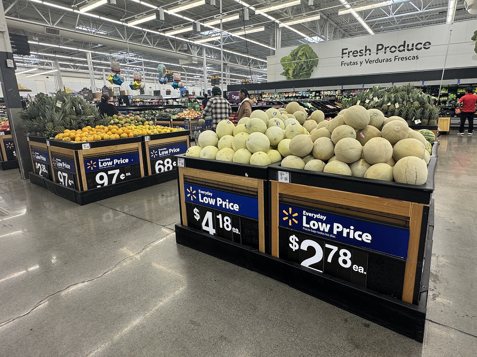 Fresh produce displays with melons, pineapples and other fruit in a Walmart supermarket