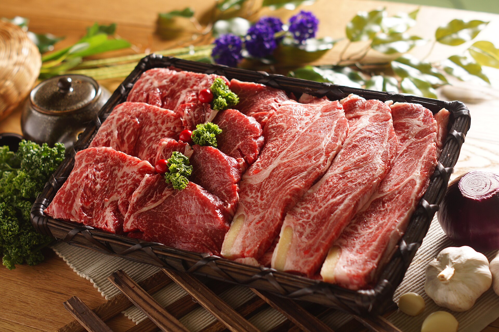 Marbled raw Korean Hanwoo beef cuts in a basket, the premium benchmark for the hybrid cultivated steak's price target