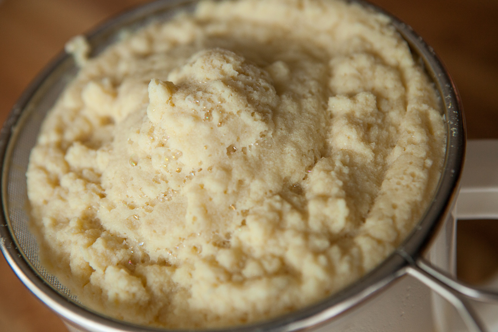 Fresh okara, the moist soybean pulp left over from soy milk and tofu production, in a sieve