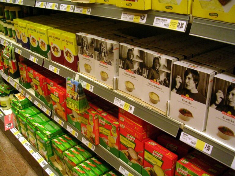 Supermarket shelf displaying private label and branded grocery products in a Swedish Hemköp store