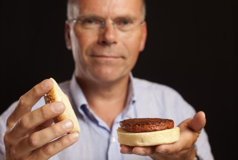 Scientist Mark Post holding the first cell-cultured beef hamburger