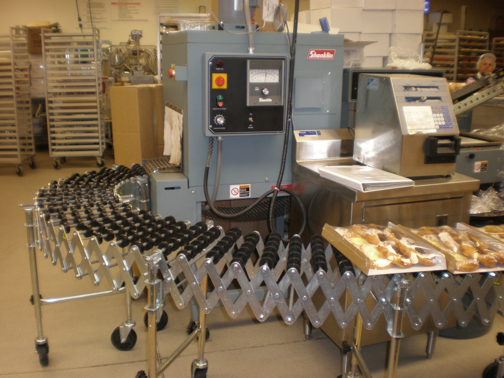 Industrial bakery pastry packaging line with packaged baked goods on a conveyor