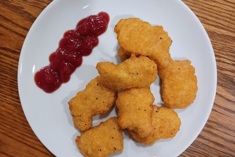 Plate of plant-based chicken nuggets with ketchup