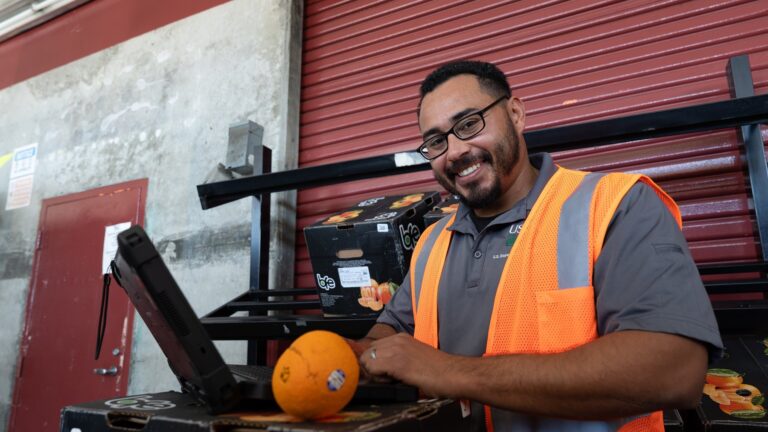 Worker weighing produce at the Los Angeles Wholesale Produce Market