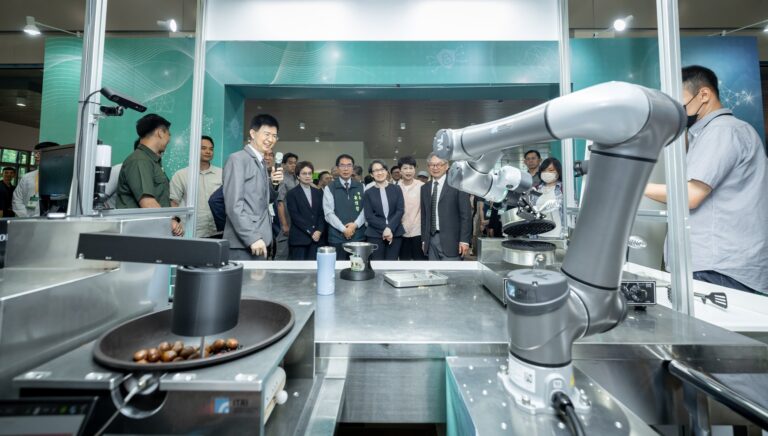 Robotic arm cooking station demonstrated at an AI technology expo in Taiwan