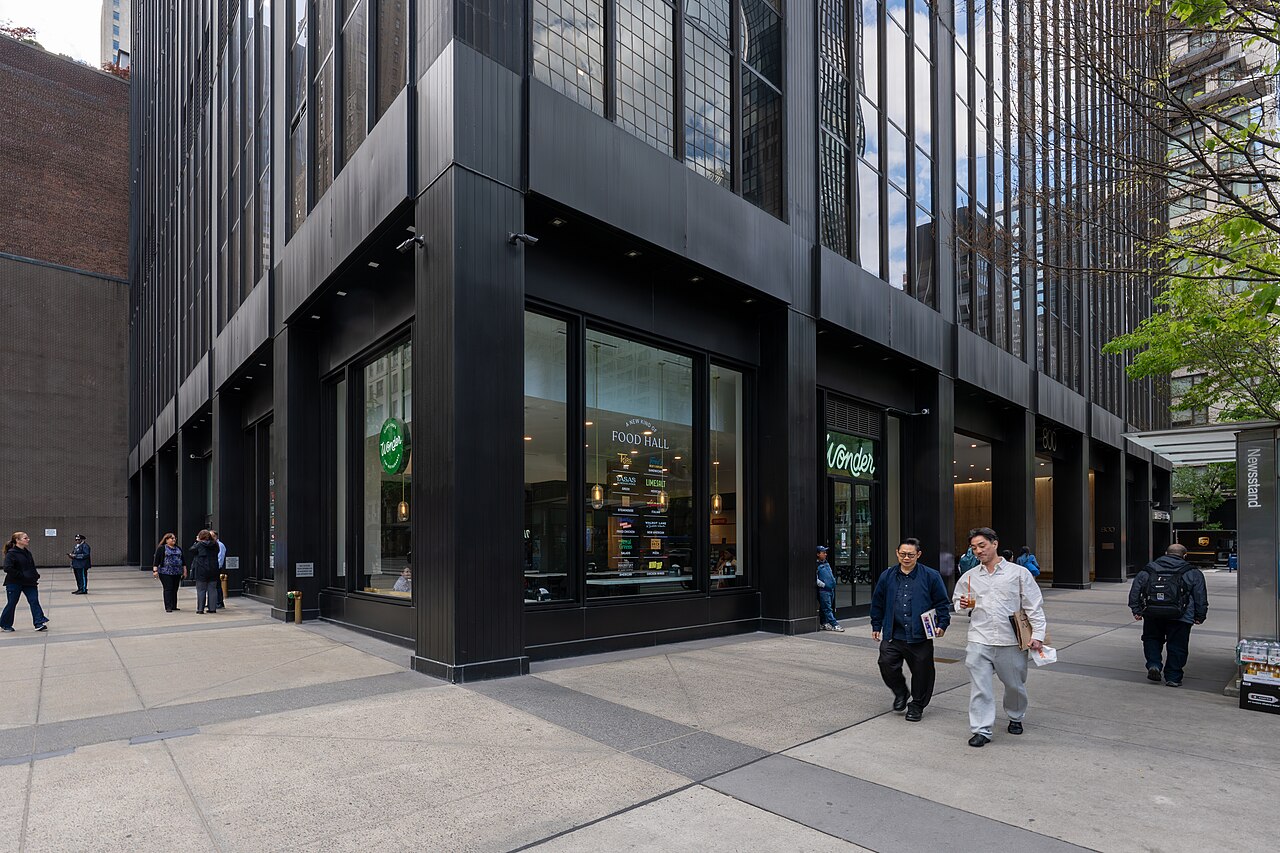 Glass-fronted Wonder food hall storefront with green logo in Midtown East, Manhattan